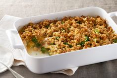 a casserole dish with broccoli and stuffing in it on a table