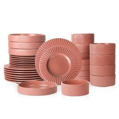 a stack of pink plates and cups sitting next to each other