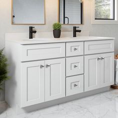 a white bathroom with two sinks and mirrors