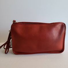 "Original Classic Coach Basic Bag Red leather with brass hardware Roomy interior with zip pocket secured by a top zipper Measures: 11\"L, 7\"H, 1.5\"W Detachable 33\" double strap Made in the New York City, USA Glue in serial #484-8121 Hooks have anchor stamp Flaw: slight discoloration on hardware and patina normal with age Cleaned, conditioned and ready to wear Questions? just ask more vtg coach styles/colors also available G46" Classic Burgundy Shoulder Bag With Zipper Closure, Red Leather Satchel With Zipper Pocket, Classic Red Shoulder Bag With Zipper Closure, Red Leather Bag With Zipper Pouch, Classic Leather Shoulder Bag With Zipper Pouch, Classic Red Bag With Zipper Pocket, Classic Red Bags With Zipper Pocket, Vintage Coach Bags, Vintage Coach