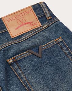 Valentino denim trousers with metallic V Detail - Carrot fit - Metallic V Detail on back pocket - Five pockets - Composition: 100% Cotton - Length: 101 cm / 39.8 in. in an Italian size 30 - Leg opening: 17.80 cm / 7.0 in. an Italian size 30 - The model is 187 cm / 6'1" tall and wears an Italian size 30 - Made in Italy The look of the model is completed by a Valentino Garavani Vlogo Signature Bag and Valentino Garavani Rockstud Shoes. Denim Trousers, Mens Denim, Valentino Garavani, Denim Pants, Online Boutique, Calf Skin, Composition, Trousers, Italy