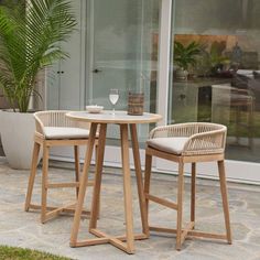 two chairs and a table in front of a glass door