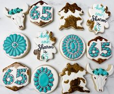 decorated cookies are arranged in the shape of cows and numbers for an anniversary or special occasion