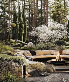 an outdoor fire pit surrounded by plants and trees