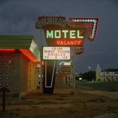 the neon motel sign is lit up for guests to use it as their own place