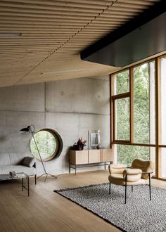 a living room filled with furniture and large windows