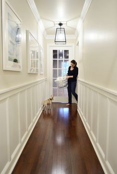 a woman is walking down the hallway with her dog in front of her and an instagram page below