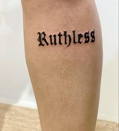 a woman's leg with the word ruthless written on it in cursive font