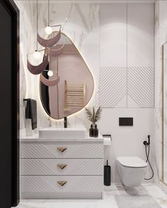 a white bathroom with gold accents and an oval mirror above the sink, along with a toilet