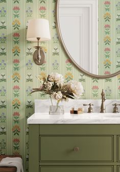 a bathroom vanity with a mirror and flowers on it