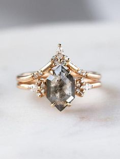 a close up of a ring with a stone and diamonds on it's side