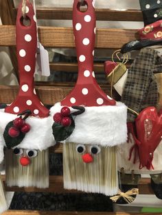 two red and white christmas decorations on top of brooms