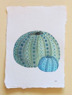 a painting of some kind of blue and green object on a white paper with polka dots