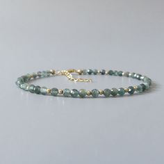 Fall in love with our dainty and rare genuine teal green kyanite gemstone beaded bracelet. Your purchase will arrive elegantly packed  in a gift-ready suede storage bag  and will include a complimentary cleaning cloth. Treat yourself or your loved ones with this high-quality handmade jewelry gift.  D E T A I L S -Genuine rare teal green kyanite faceted beads -Bead size 3mm, the bracelet appears larger in photos  -With scattered sterling silver, rose gold filled, or 14k gold filled accent beads - Faceted Beads Bracelets As May Birthstone Gift, Faceted Beads Bracelet For May Birthstone Gift, May Birthstone Bracelets With Faceted Beads As Gift, Elegant May Birthstone Beaded Bracelets, Beaded Gemstone Bracelets, Dainty Gemstone Jewelry, Kyanite Bracelet, Birthday Gift Mom, Green Kyanite