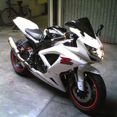 a white and black motorcycle parked in a garage