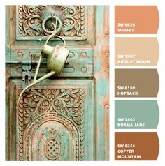 an old door with a watering can on the handle and color swatches below it