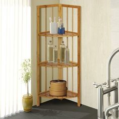 a wooden shelf with bottles and soaps on it in the corner of a bathroom