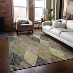 a living room with two white couches and a large rug on the wooden floor