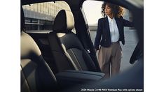 a woman standing in the back seat of a car