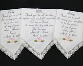 three personalized handkerchiefs with pink roses on them and the names of their guests