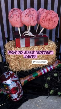 there are some creepy candy pops on top of a cart with straw bales around it