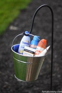 a metal bucket filled with lots of different items