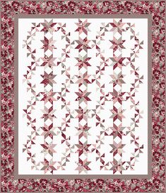 a red and white quilt with an intricate design on the front, along with a border