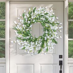 a white door with a wreath on it