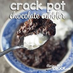 a spoonful of ice cream and chocolate cake in a blue and white bowl on a wooden table