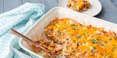 a casserole dish with chicken, cheese and herbs in it on a table