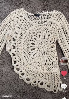 a crocheted sweater with buttons on the bottom and an image of a pair of sunglasses