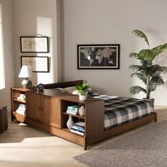 a bed room with a neatly made bed and a plant