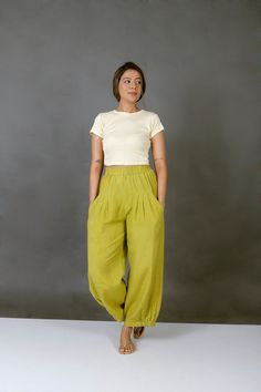 "Unisex Apple Green pants for women, Custom made baggy pant, Bohemian pants, Made to order, Plus size Perfect for summer days.. goes well with cropped top.. Comfy baggy pants.. -Model height: 5'3\" wearing size S -Length: 36\" -Fit: Comfortable -Closure: Elasticated waist Style these linen pants with casual tops or our tank tops. You would want to wear these everyday!" Summer Green Harem Pants With Tapered Leg, Relaxed Fit Green Harem Pants, Green Tapered Leg Harem Pants For Summer, Summer Green Tapered Leg Harem Pants, Spring Bohemian Tapered Leg Pants, Bohemian Harem Pants With Tapered Leg For Spring, Bohemian Spring Harem Pants With Tapered Leg, Spring Bohemian Harem Pants With Tapered Leg, Spring Bohemian Tapered Leg Harem Pants