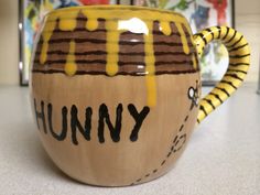 a ceramic coffee mug with the word funny painted on it