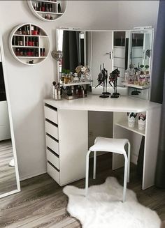 a white vanity with lots of makeup on it