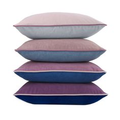 four pillows stacked on top of each other in different colors and sizes, with the same color