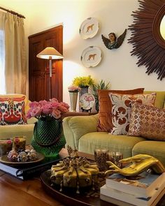 a living room filled with lots of furniture and decor on top of a wooden table