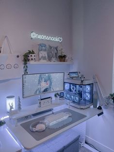 a white desk topped with a computer monitor and keyboard