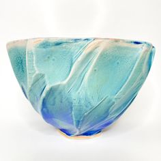 a blue and white bowl sitting on top of a table