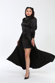 Crafted from a premium blend of 60% polyester, 37% cotton, and 3% spandex, the Genesis dress embodies luxury with its Dolce Satin fabric, offering a smooth, slightly stretchy feel that drapes beautifully and moves with grace. Designed to flatter, its silhouette hugs curves elegantly, enhanced by dramatic puff sleeves and a flowing cape that adds sophistication and movement. Versatile and effortlessly chic, the Genesis dress transitions seamlessly from day to night, whether styled with heels and Fitted Pre-draped Long Sleeve Maxi Dress, Fitted Long Sleeve Pre-draped Evening Dress, Fitted Pre-draped Satin Evening Dress, Long Sleeve Satin Dress For Gala, Pre-draped Long Sleeve Evening Midi Dress, Fitted Pre-draped Knee-length Dress, Fitted Asymmetrical Pre-draped Dress, Evening Pre-draped Long Sleeve Midi Dress, Fitted Pre-draped Asymmetrical Cocktail Dress