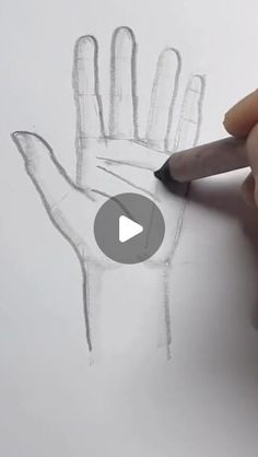 someone is drawing a hand with pencils on paper