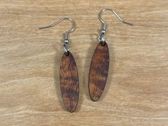 Discover the allure of our Koa Wood Earrings. Handcrafted from sustainable sources, these lightweight beauties feature the warm tones and unique grain patterns of Koa wood. Elevate your style with nature's elegance. Perfect for any occasion. Features: * Length - 1 1/2 inches * Drop length - 2 3/16 inches * Width - 3/8 inches * Light weight * Hypoallergenic ear wire * Made in Hawaii Shipping Details: Free shipping on orders over $35 U.S.A. only All orders are processed within 2-3 business days. O Brown Wooden Drop Earrings, Brown Wood Drop Earrings, Everyday Brown Wood Earrings, Koa Wood, Wood Earrings, Ear Wire, Jewelry Earrings Dangle, Etsy Earrings, Dangle Drop Earrings