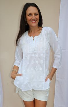 Theigh length tunic /Kurta with full front button opening is one of the gorgeous attire for warm weather. Airy and lightweight companion for a hot summer day. This beautiful Hand embroidered tunic/top is ideal for any functions/party. If you want a classic look then pair it with leggings, skinny jeans, capri. This is a contemporary reflection of traditional Indian Chikan embroidered ethnics which had originated centuries ago in Lucknow. Chikansazi is the exquisite needlework of fine and delicate Summer Floral Embroidered Straight Kurta Top, Floral Embroidered Straight Kurta Top For Summer, Summer V-neck Tunic With Chikankari Embroidery, Summer Blouse With Floral Embroidery, Straight Kurta Style, Summer Blouse With Floral Embroidery In Straight Kurta Style, White Tunic With Chikankari Embroidery, White Tunic With Resham Embroidery, Floral Embroidered Straight Kurta Blouse For Summer, White Chikankari Embroidered Tunic