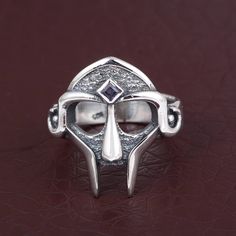 "Free Shipping on All Orders ❥ Description:- MF DOOM Mask Ring | Gladiator / Dr Doom Gold / Silver Hip Hop Statement SIZE :- All Size Are Available, choose from variation. METAL :- Pure brass, Brass rose fill, Brass gold fill, Sterling silver, Silver rose fill, Silver gold fill (choose from variation) ❥ Benefits of Brass Metal : Brass has metaphysical healing properties to boost the immune system and to give courage. It's known to help reduce inflammation and also improve digestion. Brass has th Doom Ring, Gladiator Ring, Doom Mask, Mf Doom Mask, Dr Doom, Fake Stone, Mf Doom, Metaphysical Healing, Lapis Ring