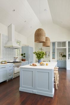 a large kitchen with an island in the middle