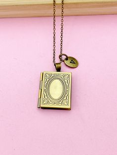 a necklace with a book and a key on it