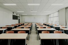 an empty classroom with desks and chairs