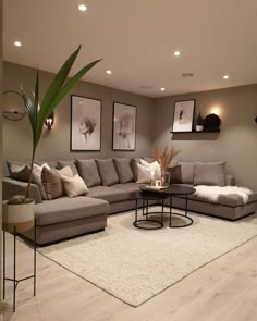 a living room filled with furniture and pictures on the wall