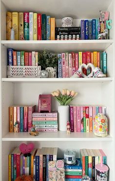 the bookshelves are filled with many different types of books and vases on them