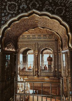 the inside of an ornate building with people standing on balconies and looking out